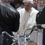 Pope Francis is seen next to a Harley Davidson motorcycle during the weekly audience in Saint Peter's Square at the Vatican