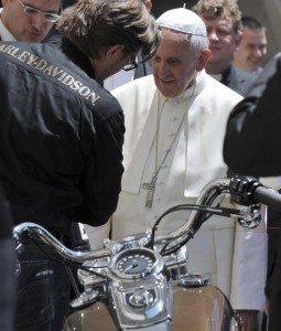 Pope Francis is seen next to a Harley Davidson motorcycle during the weekly audience in Saint Peter's Square at the Vatican